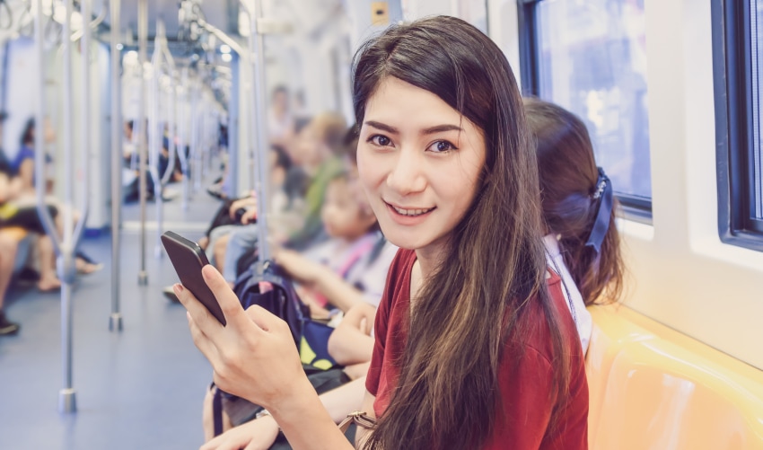 Middle class Thai girl on her way to work in Bangkok's BTS metro