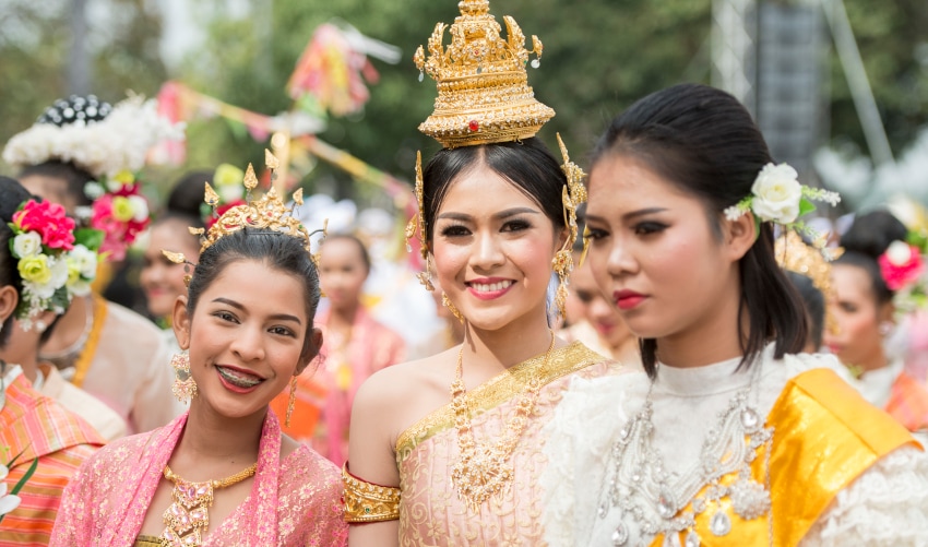 Thai girls dressed in traditional attire preparing at a festival in Isan, Thailand